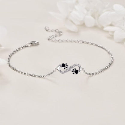 Pulsera con colgante de pata de mascota y símbolo de infinito con circonita cúbica