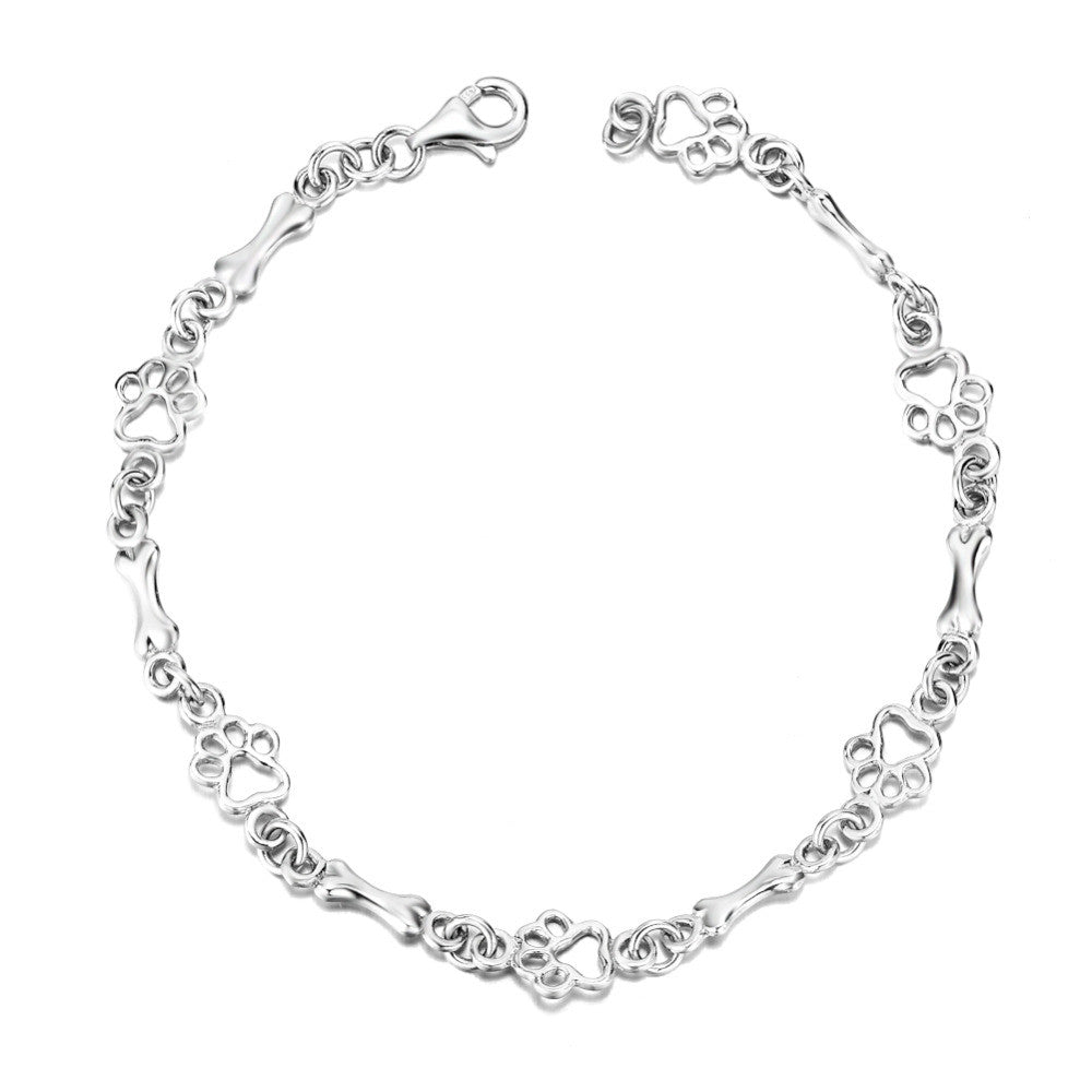 Pulsera de plata con dije de pata de perro y hueso